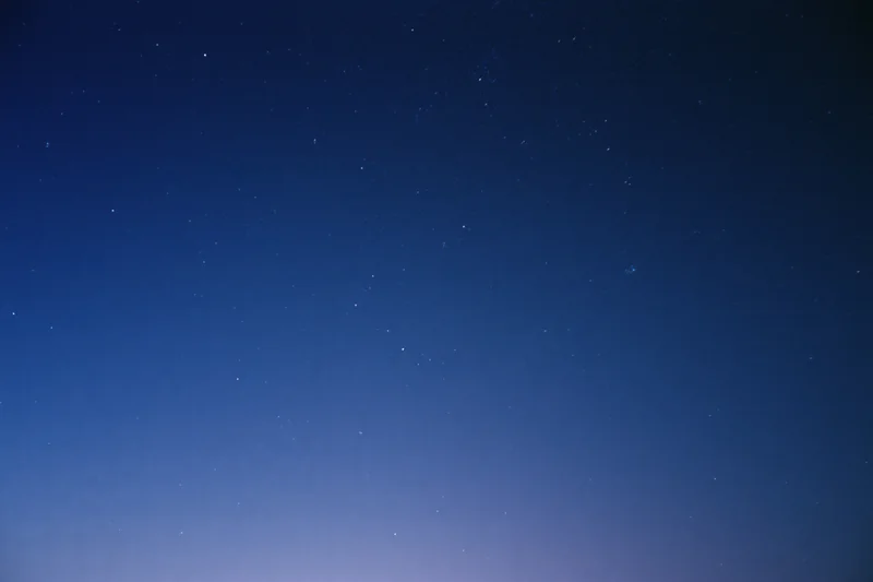 Clear night sky filled with scattered faint stars, no horizon visible