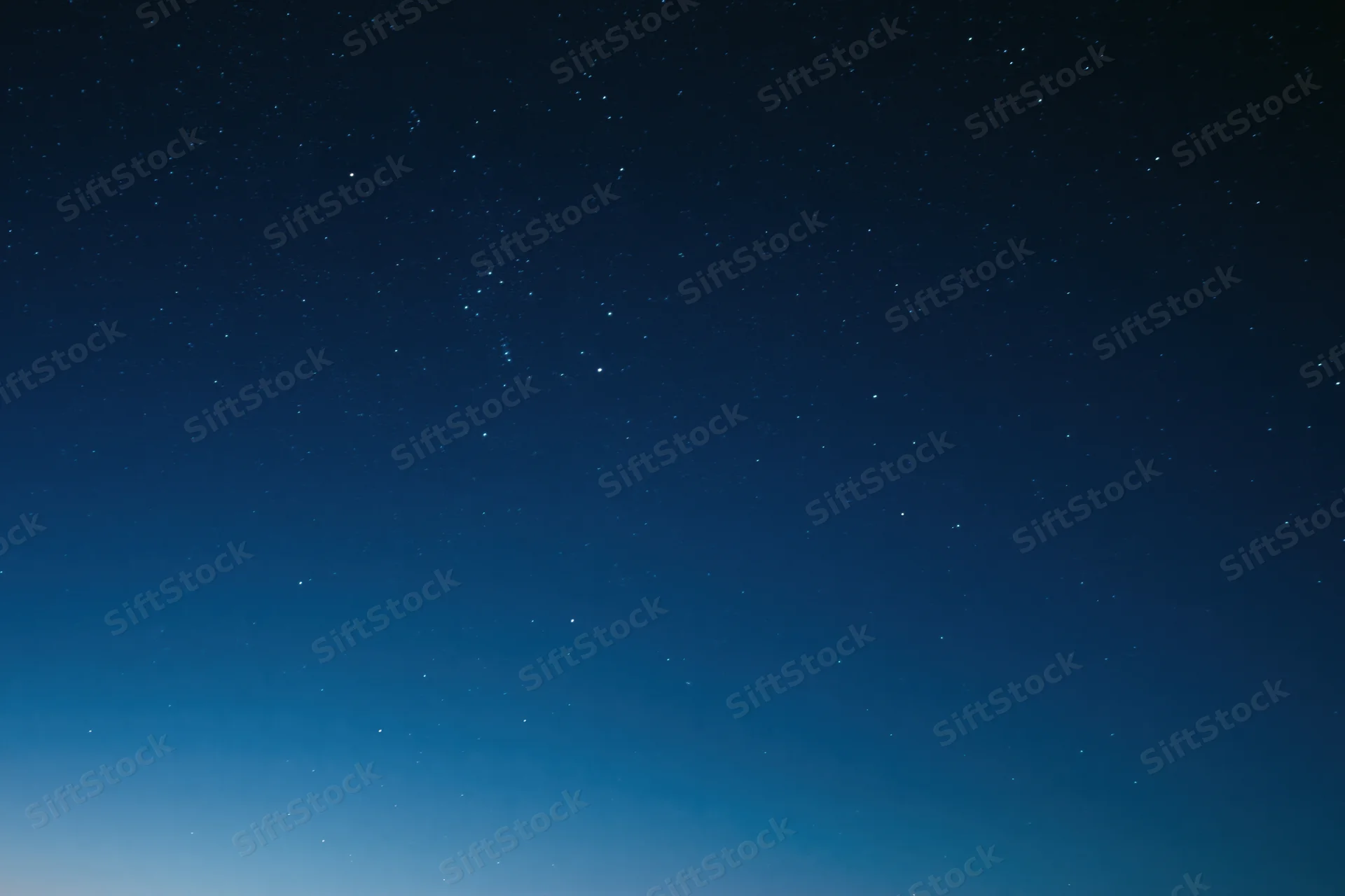 Dark blue night sky filled with scattered faint stars, no horizon visible
