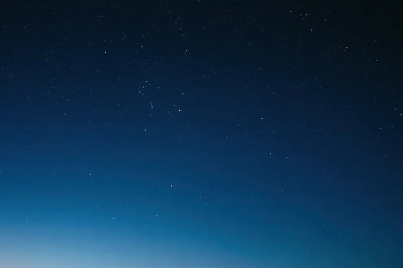 Dark blue night sky filled with scattered faint stars, no horizon visible