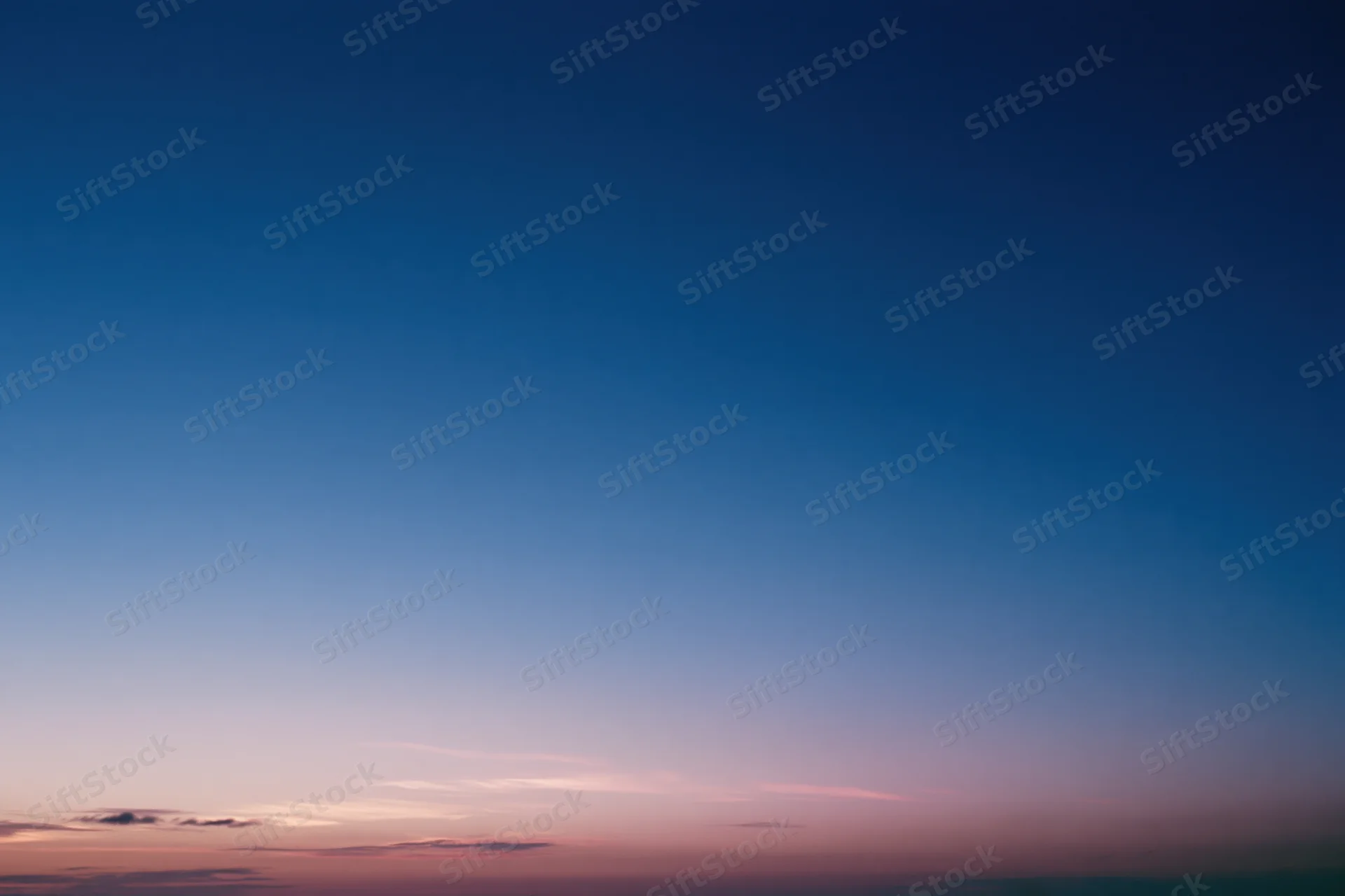 Twilight sky with soft blue and pink gradient transitioning from dusk to evening