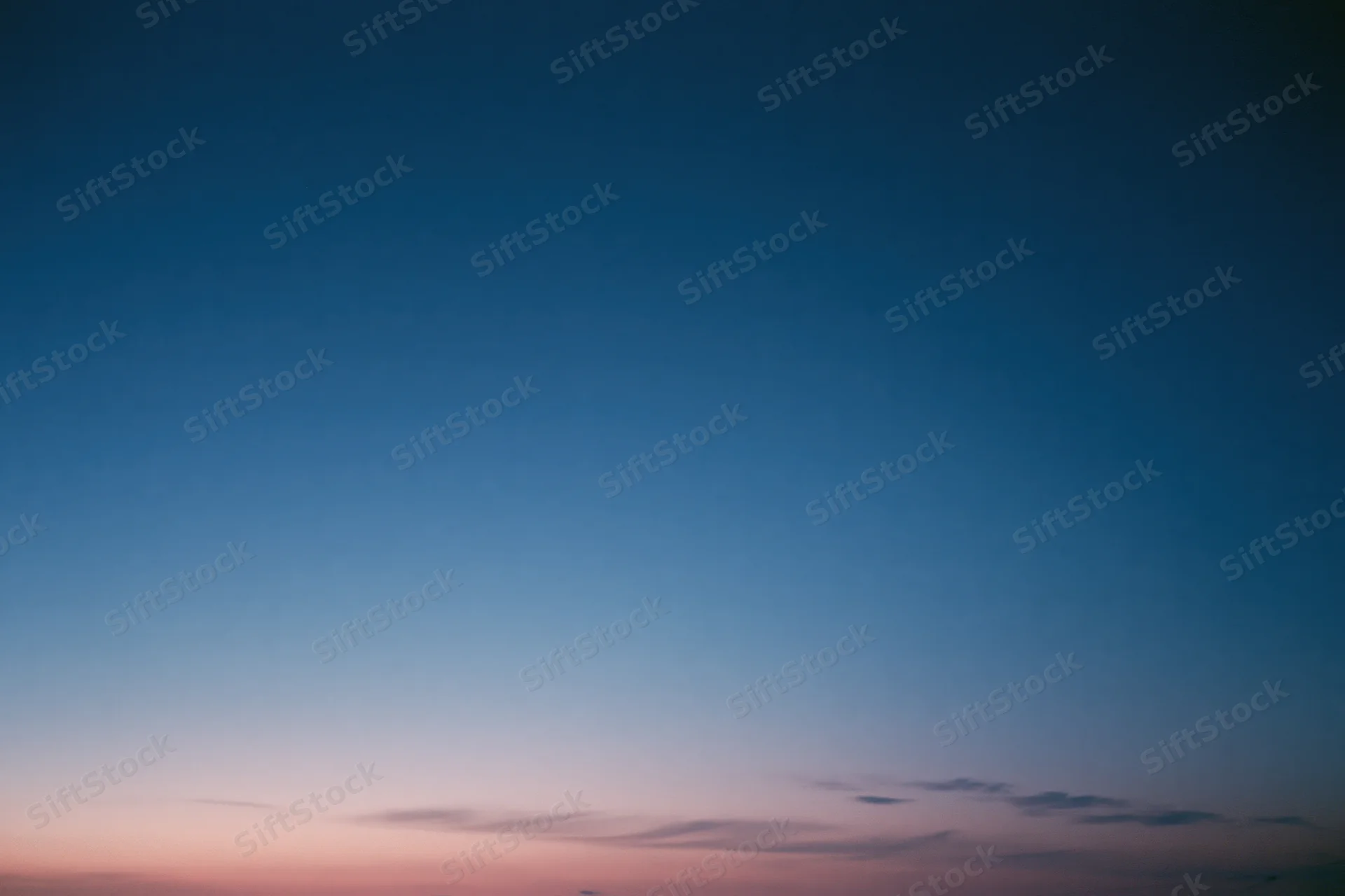Twilight sky with soft blue and pink gradient transitioning from dusk to evening