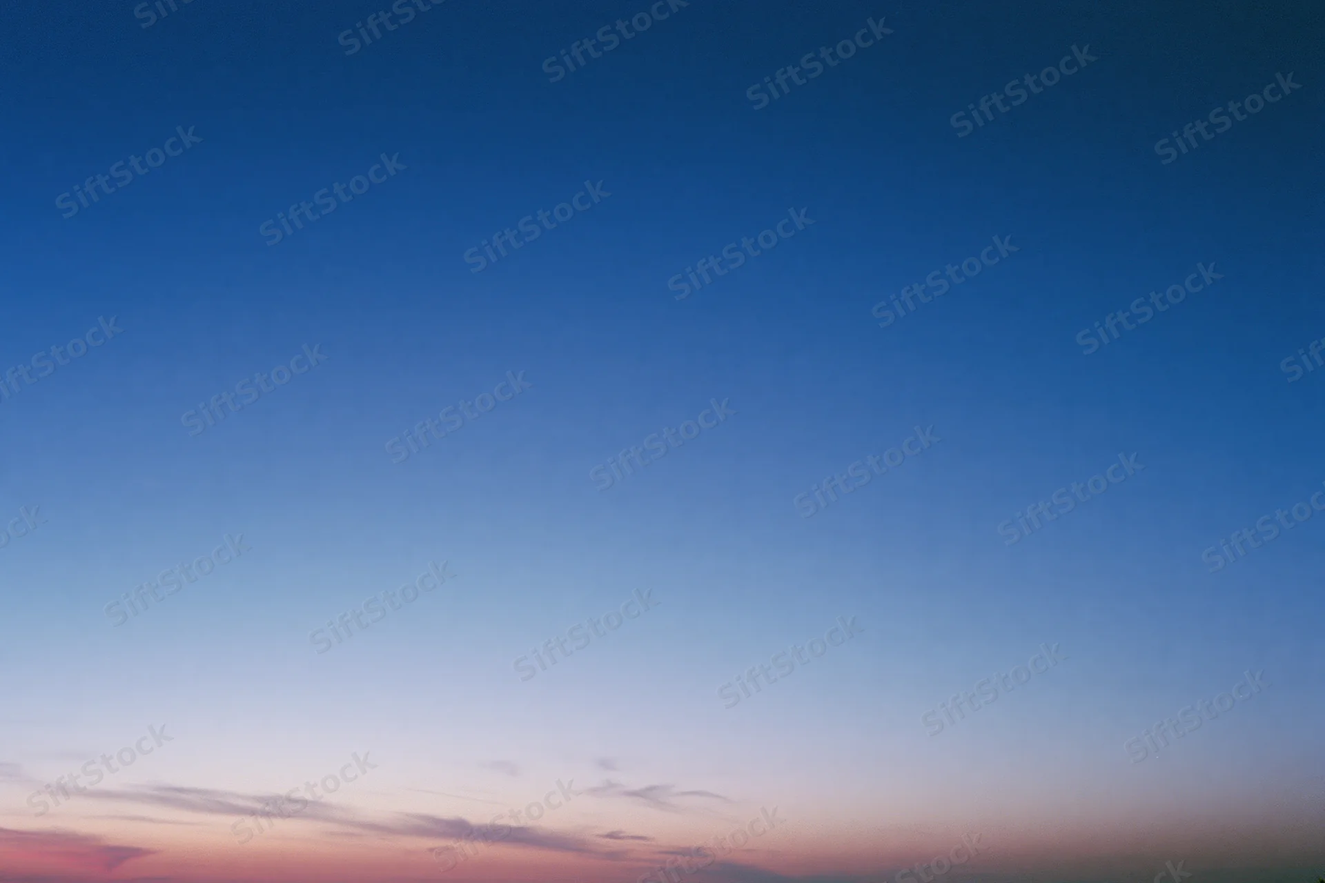 Twilight sky with soft gradient from deep blue to pink and purple near the horizon