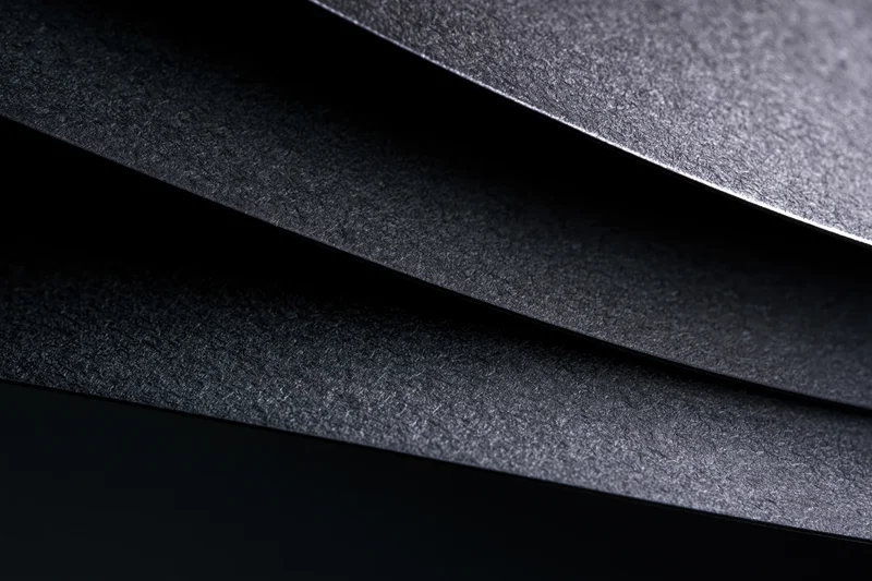 Layered black cardstock sheets in close-up abstract arrangement