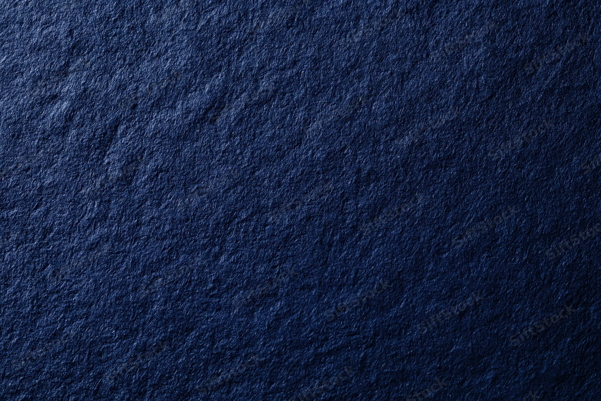 Close-up of dark navy blue textured surface filling the frame