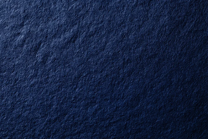 Close-up of dark navy blue textured surface filling the frame