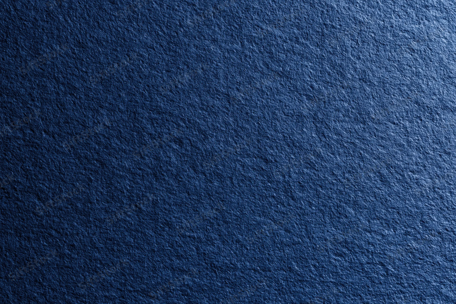 Close-up of dark navy blue textured fabric surface filling the frame