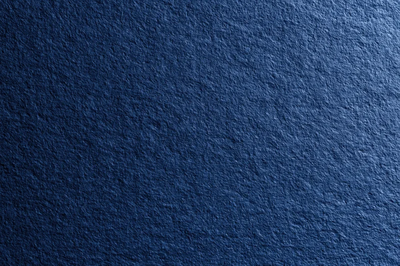 Close-up of dark navy blue textured fabric surface filling the frame