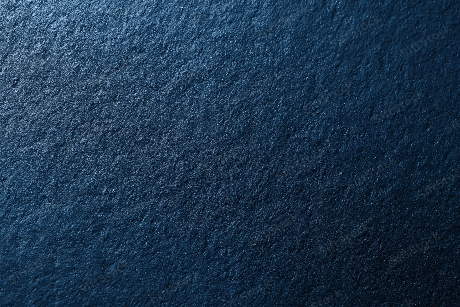 Close-up of dark navy blue textured surface filling the frame