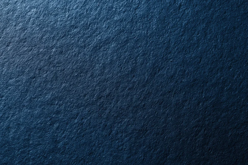 Close-up of dark navy blue textured surface filling the frame