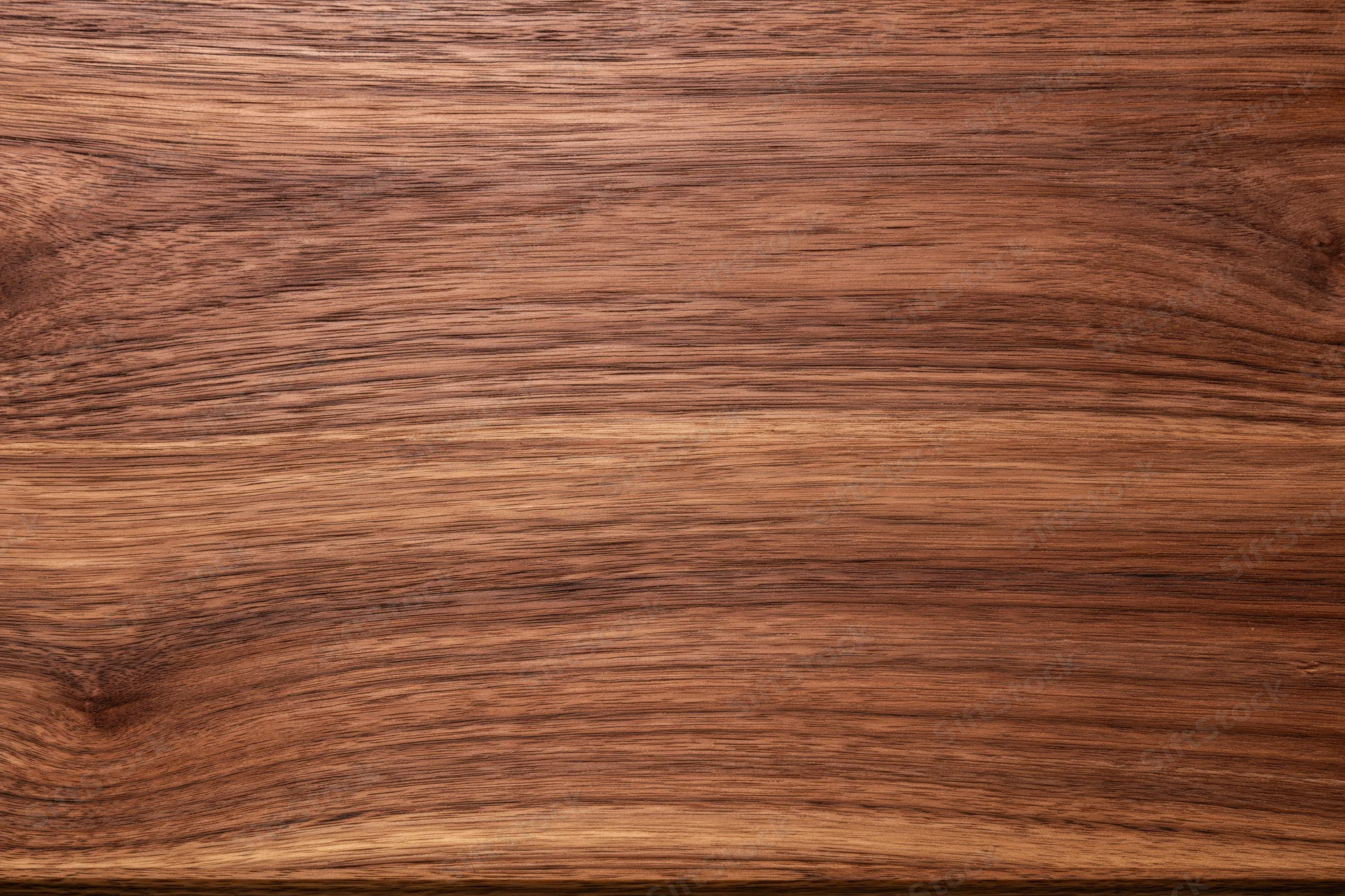 Close-up of dark walnut wood surface showing natural grain and texture
