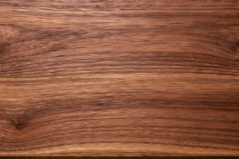 Close-up of dark walnut wood surface showing natural grain and texture