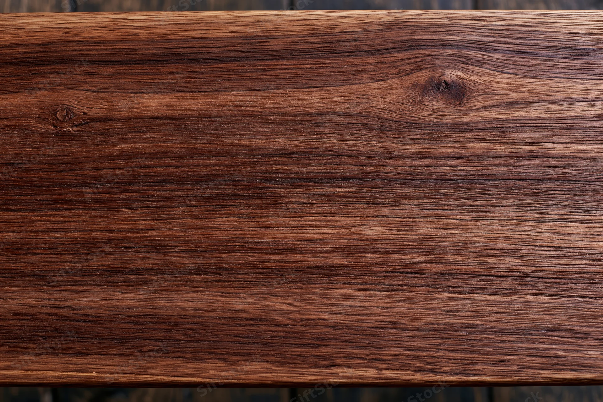 Close-up of dark walnut wood surface showing natural grain and texture