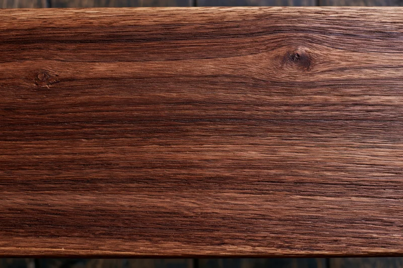 Close-up of dark walnut wood surface showing natural grain and texture