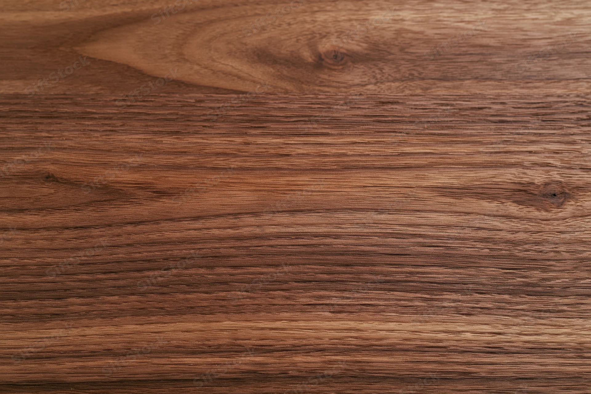 Close-up of dark walnut wood surface showing natural grain and texture