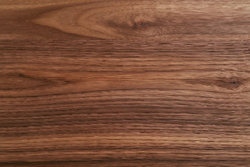 Close-up of dark walnut wood surface showing natural grain and texture