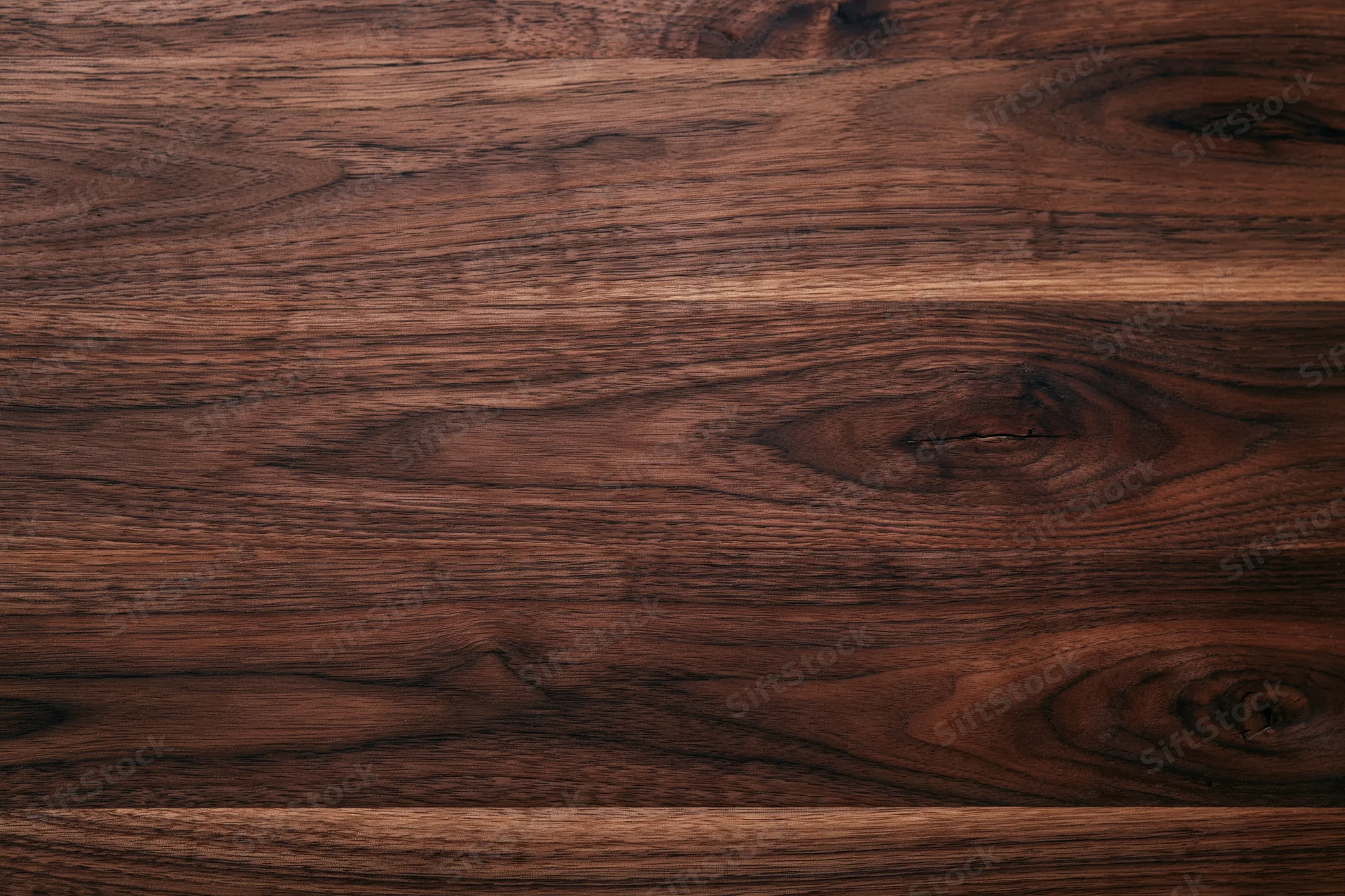 Close-up of dark walnut wood surface showing natural grain and texture