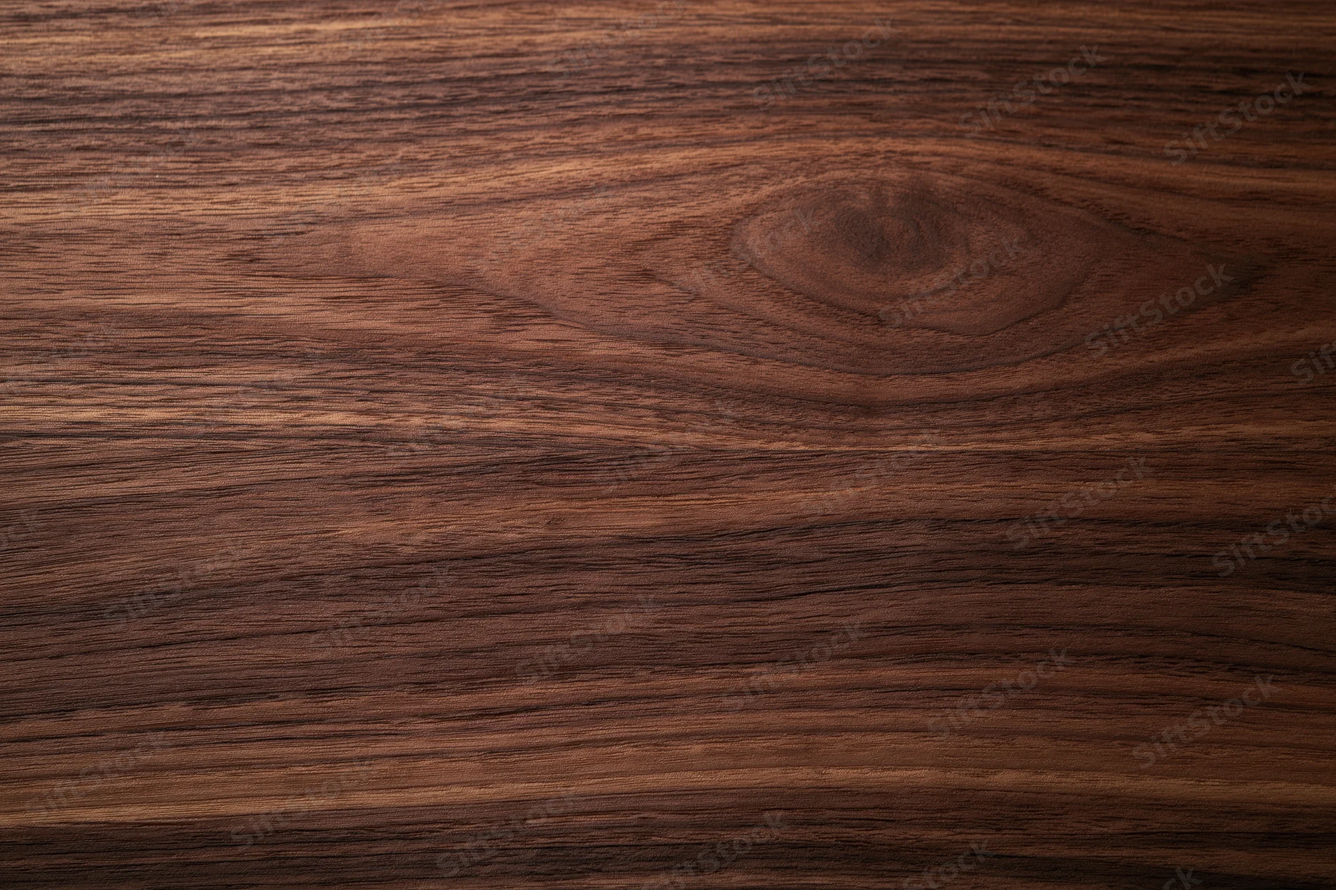 Close-up of dark walnut wood surface showing natural grain and texture
