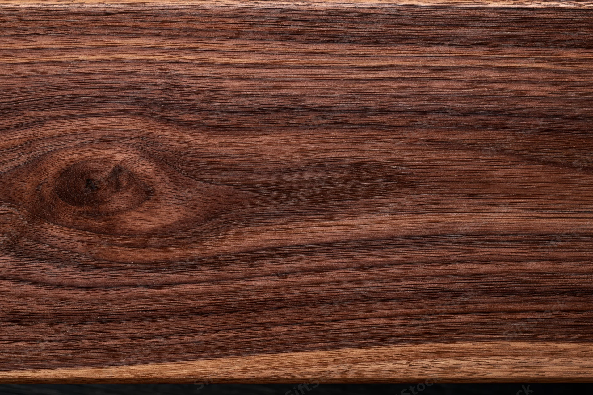 Close-up of dark walnut wood surface showing natural grain and texture