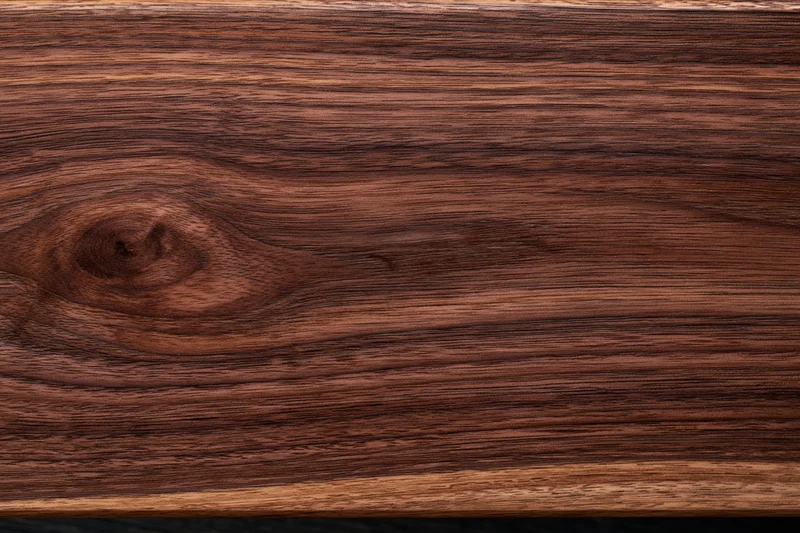 Close-up of dark walnut wood surface showing natural grain and texture