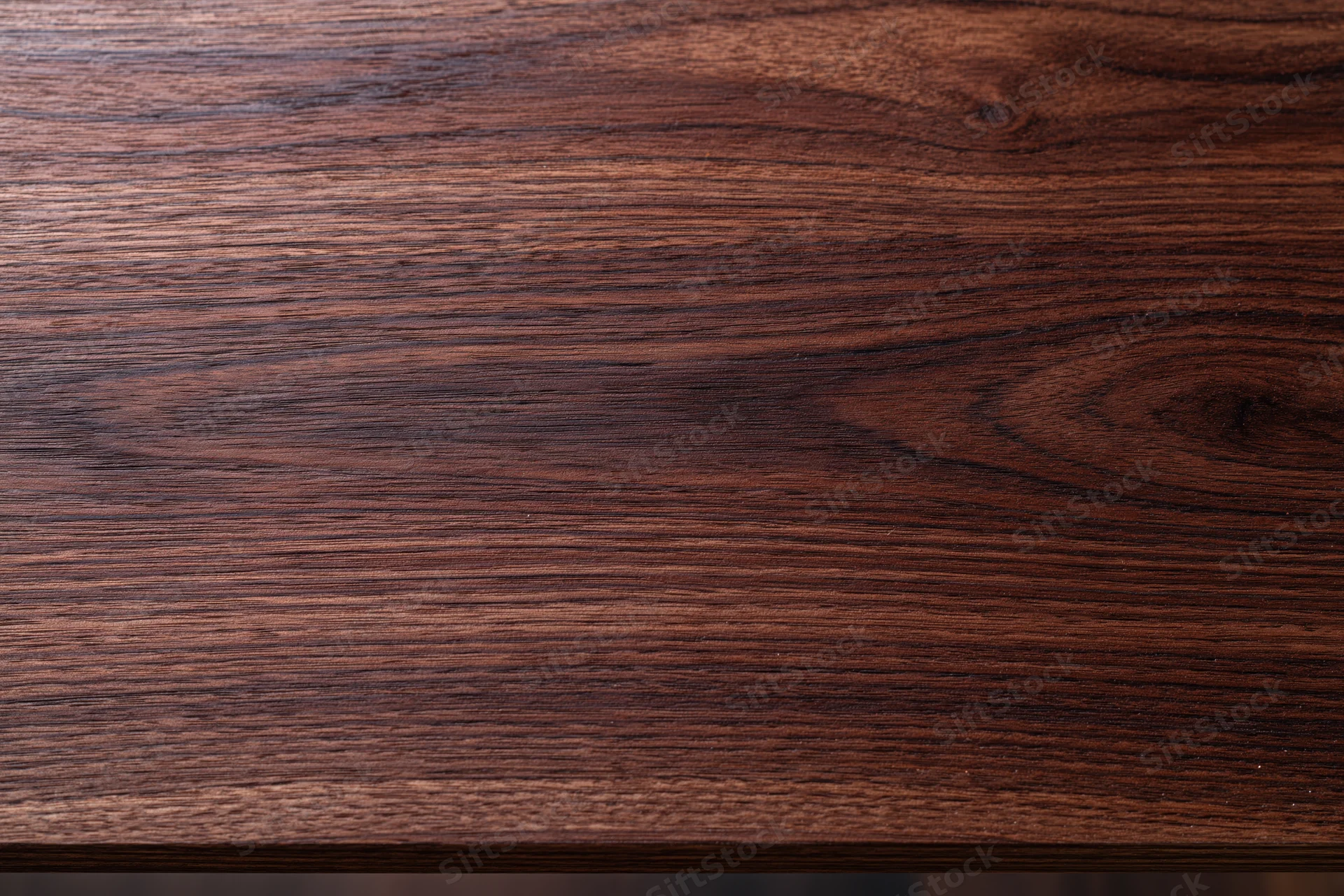Close-up of dark walnut wood surface showing natural grain and texture