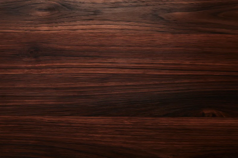 Close-up of dark walnut wood surface showing natural grain and texture
