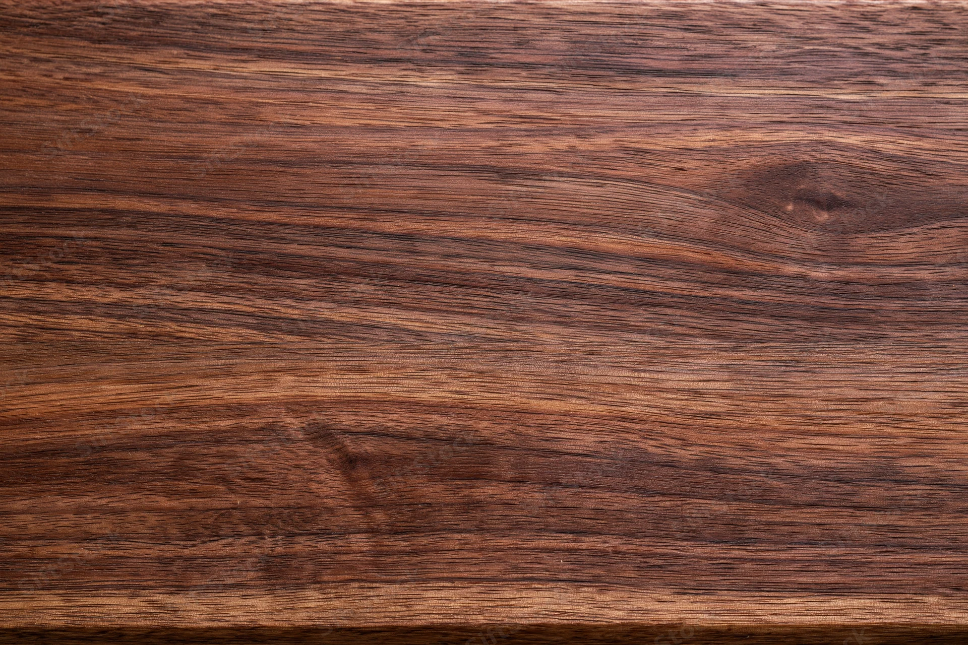 Close-up of dark walnut wood surface showing natural grain and texture
