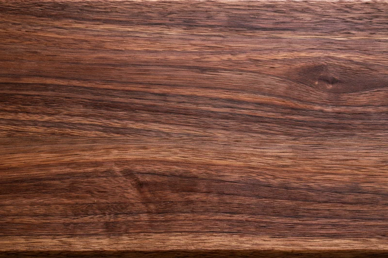 Close-up of dark walnut wood surface showing natural grain and texture
