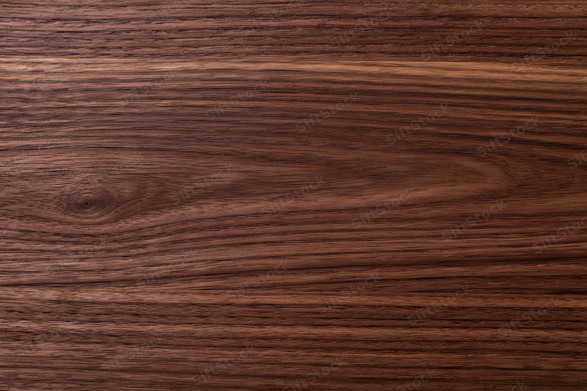 Close-up of dark walnut wood surface showing natural grain and texture