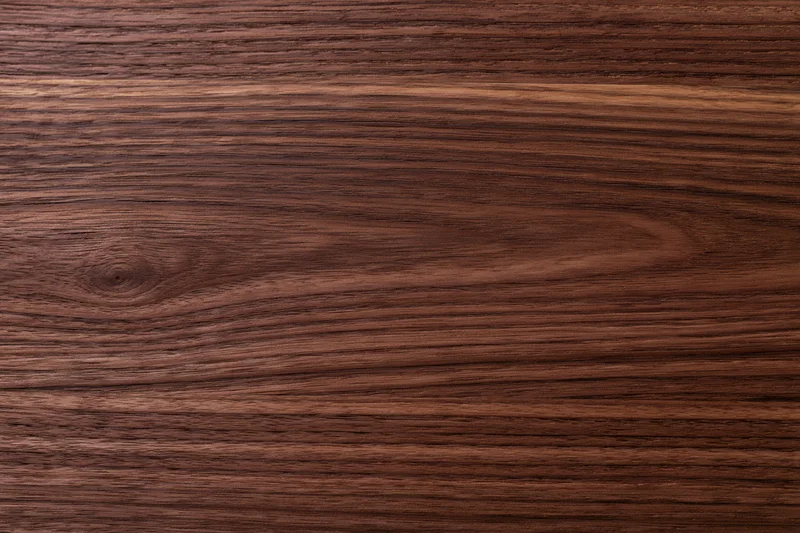 Close-up of dark walnut wood surface showing natural grain and texture