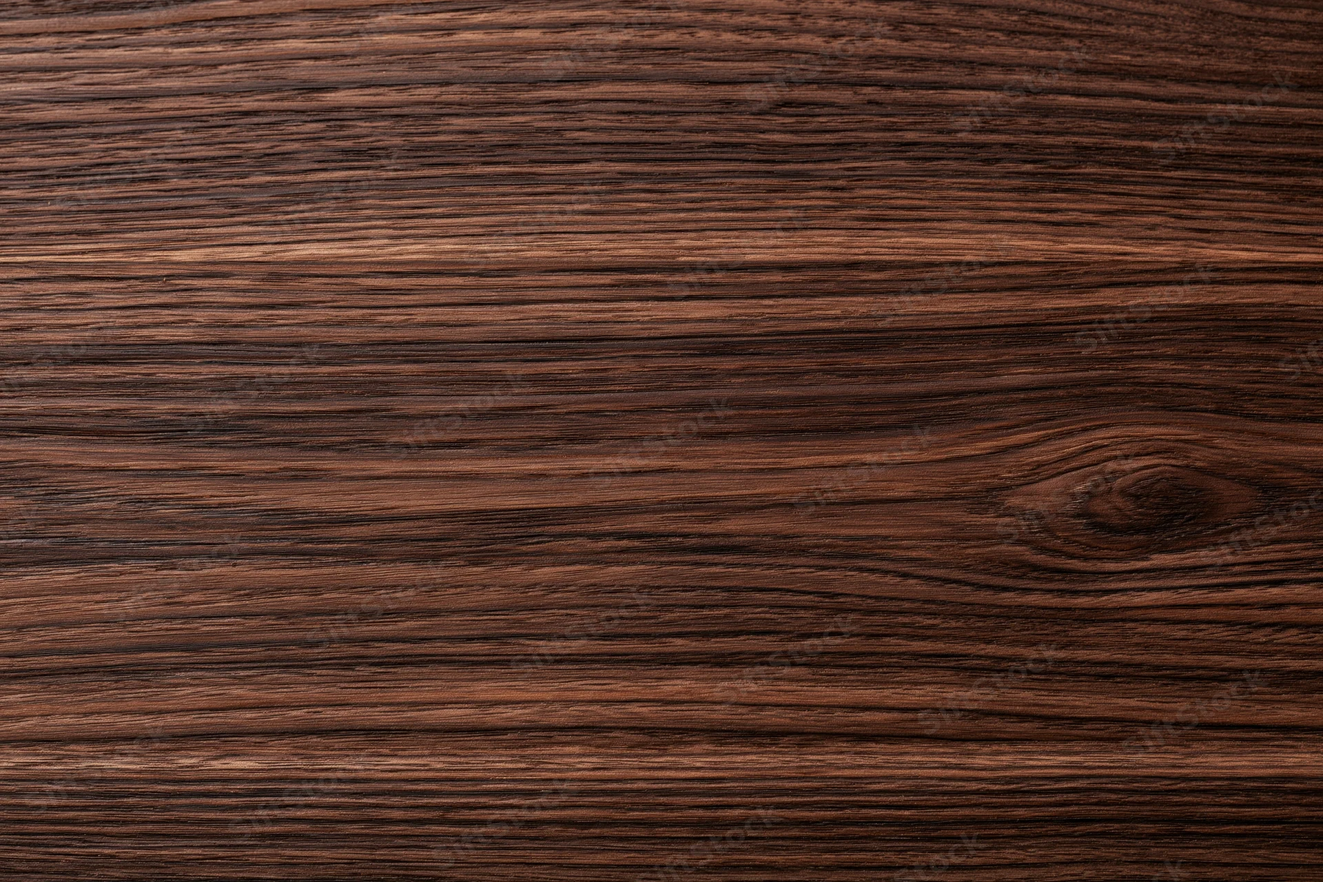 Close-up of dark walnut wood surface showing natural grain and texture