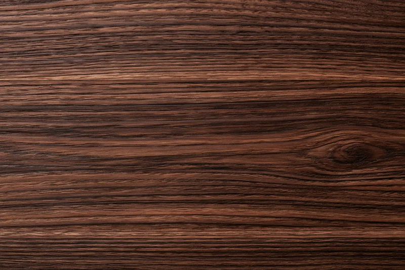Close-up of dark walnut wood surface showing natural grain and texture