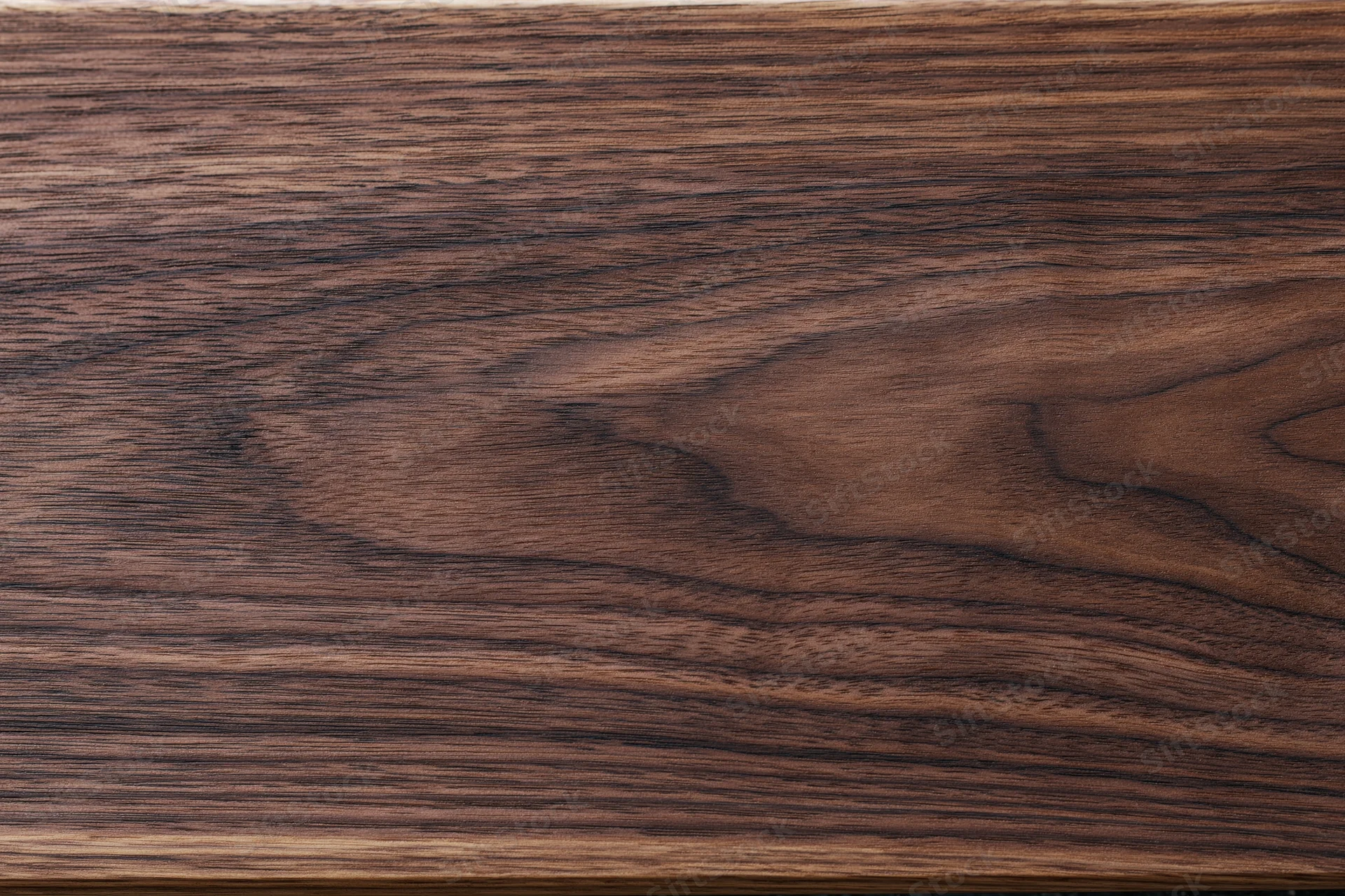 Close-up of dark walnut wood surface showing natural grain and texture