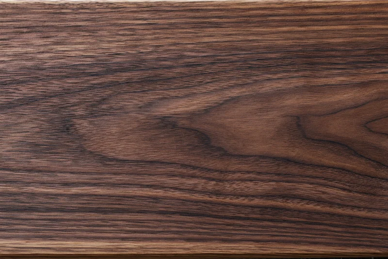 Close-up of dark walnut wood surface showing natural grain and texture