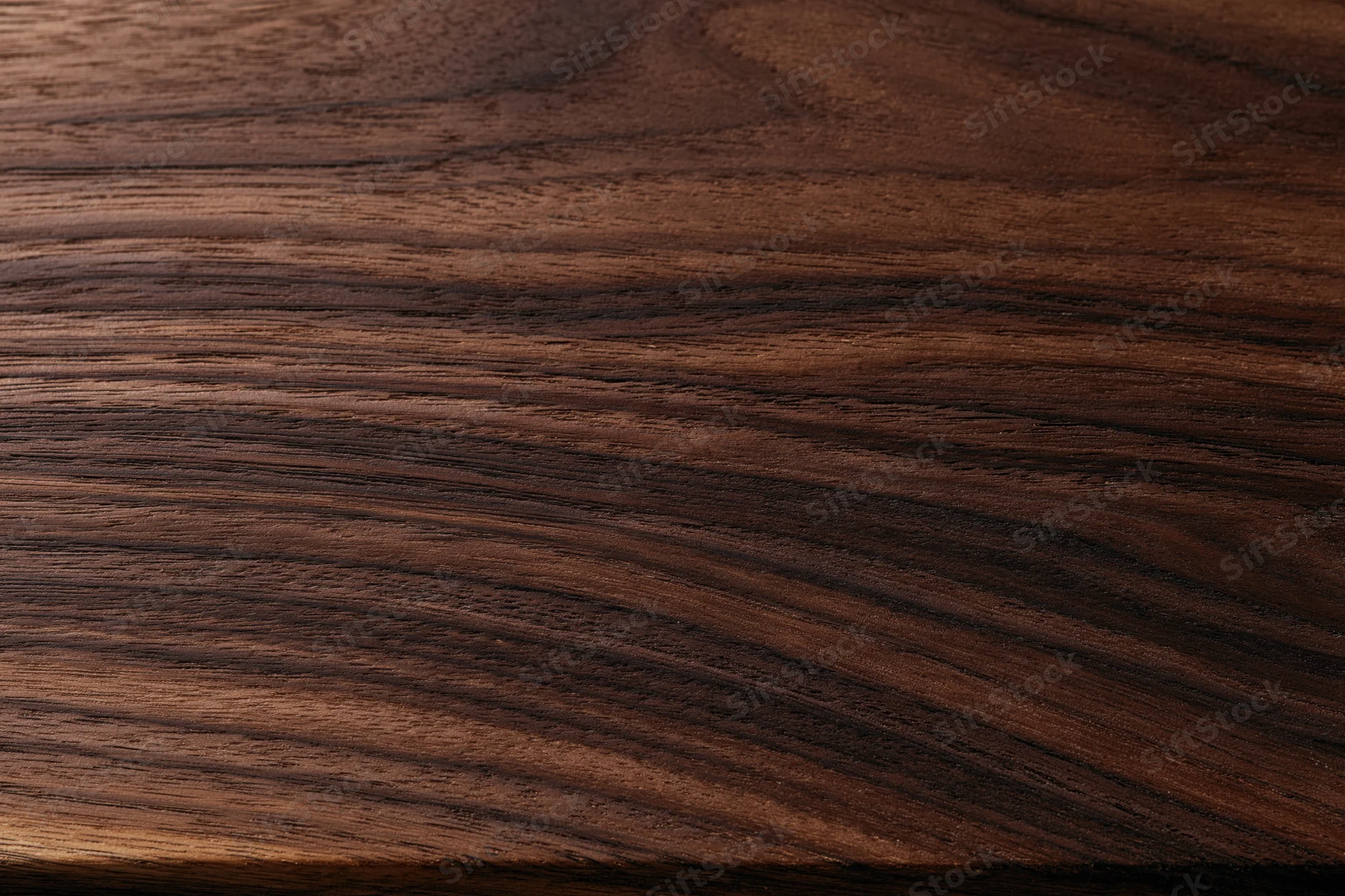 Close-up of dark walnut wood surface showing natural grain and texture