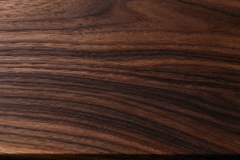 Close-up of dark walnut wood surface showing natural grain and texture