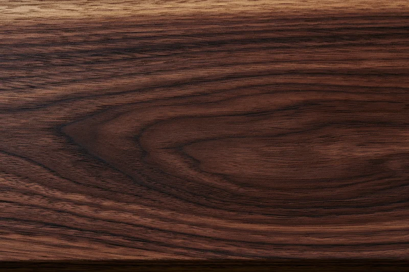 Close-up of dark walnut wood surface showing natural grain pattern