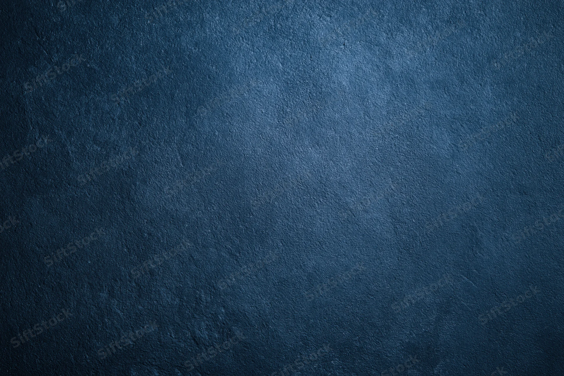 Close-up of a deep navy blue textured surface with subtle gradient and rough finish