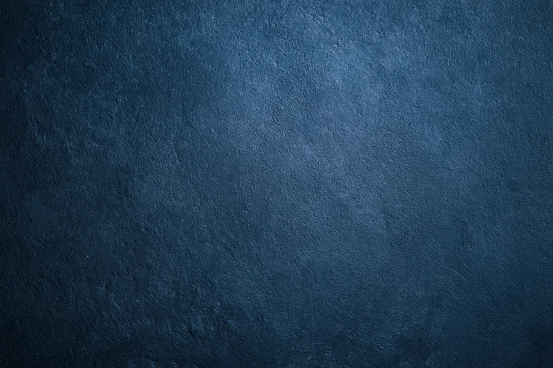 Close-up of a deep navy blue textured surface with subtle gradient and rough finish