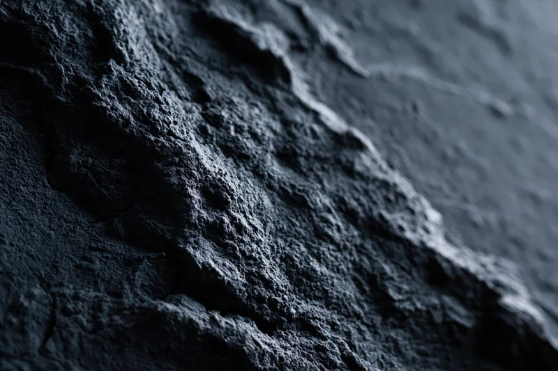 Close-up of rough dark slate surface with natural texture and depth