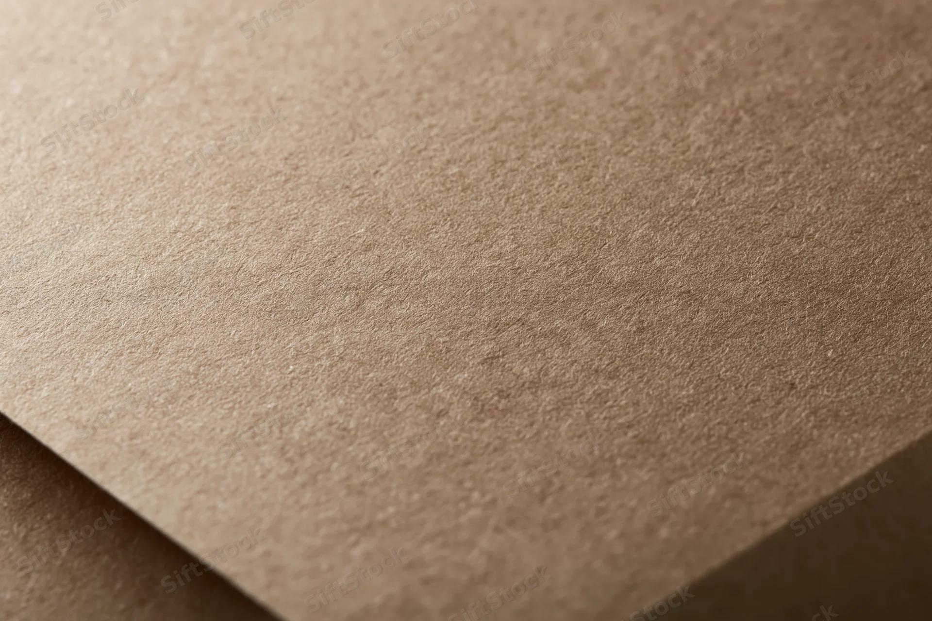 Close-up of smooth matte brown kraft paper surface in flat lay arrangement