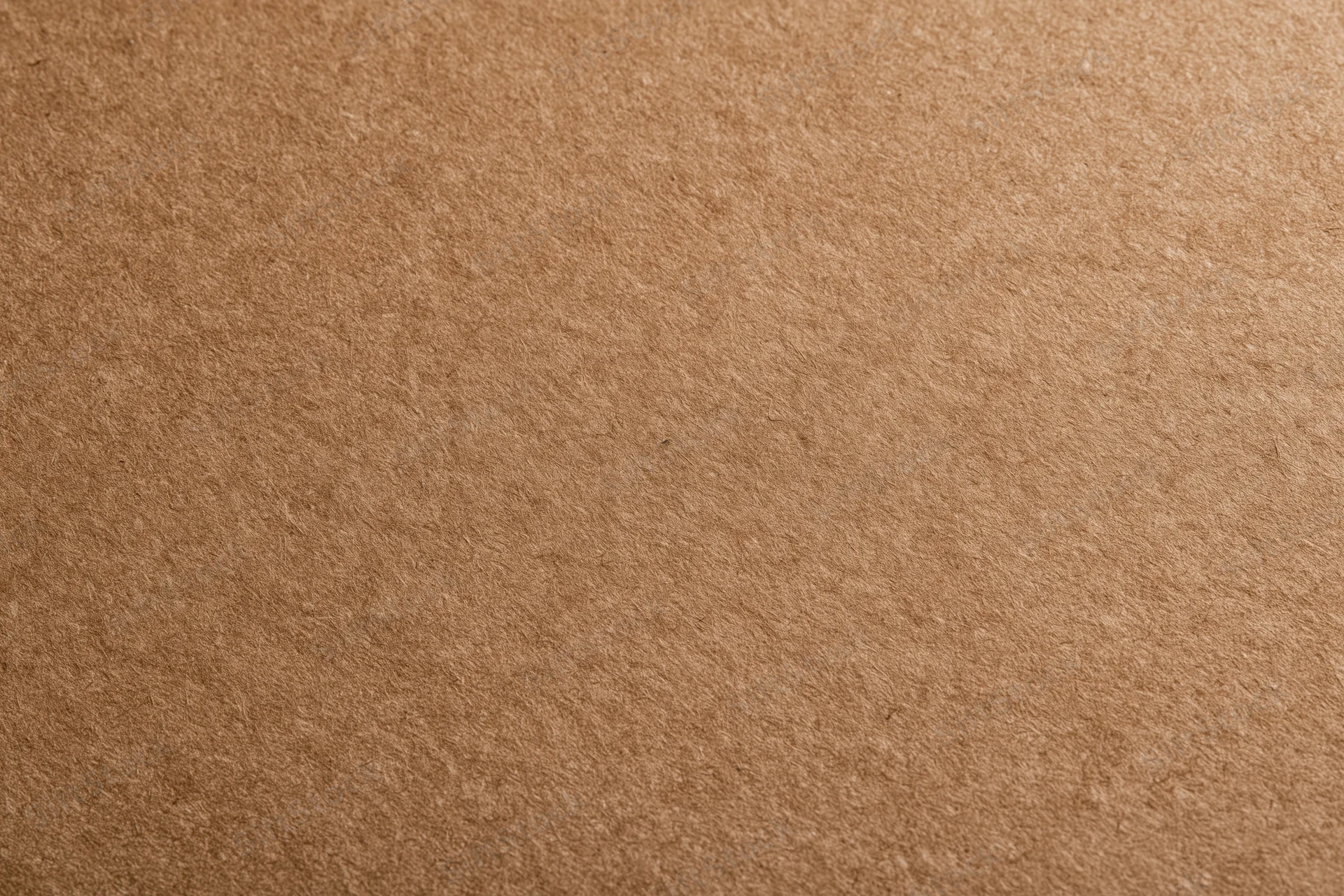 Close-up of smooth matte brown kraft paper surface in flat lay arrangement