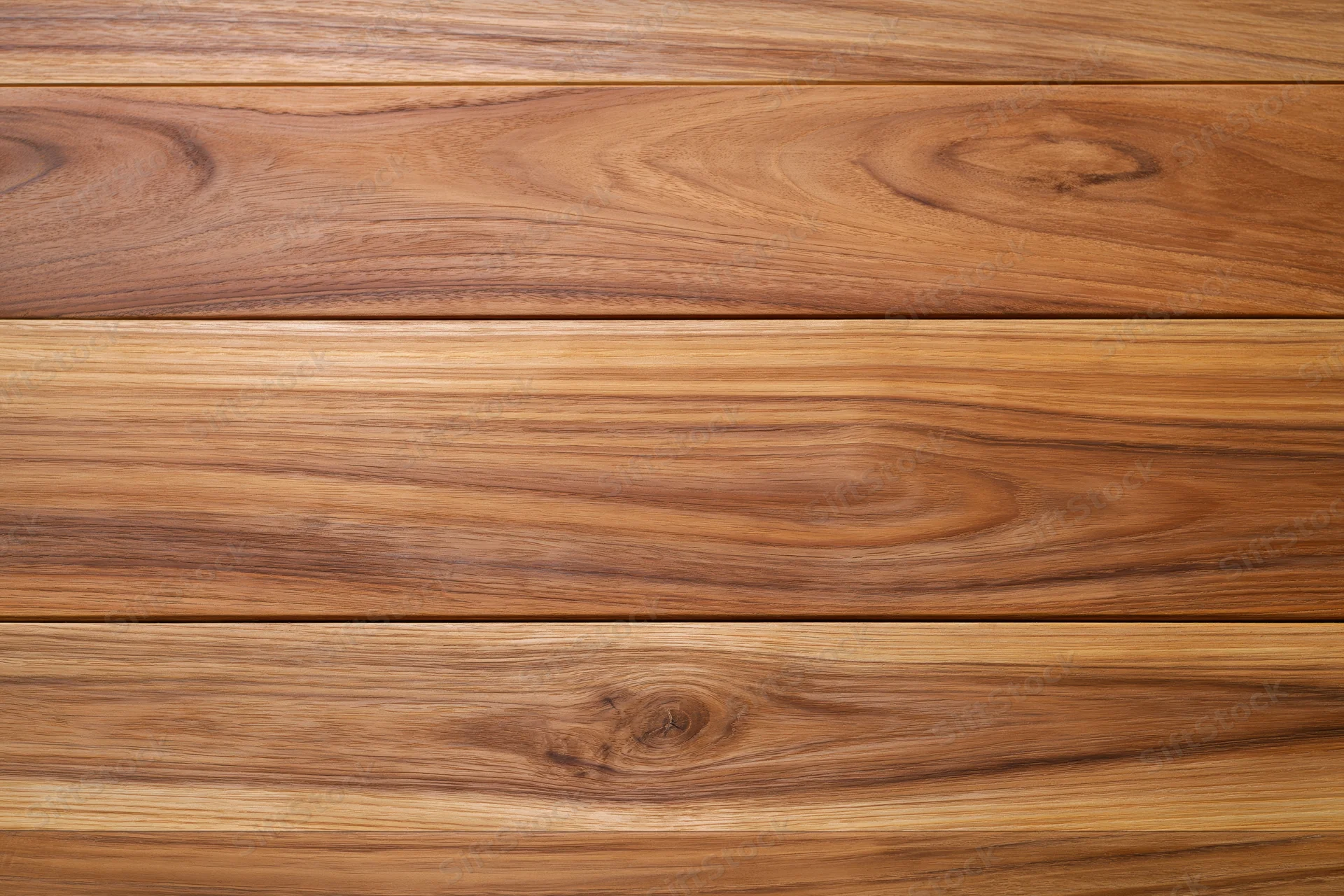 Close-up of smooth teak wood planks arranged horizontally showing natural grain and warm brown tones