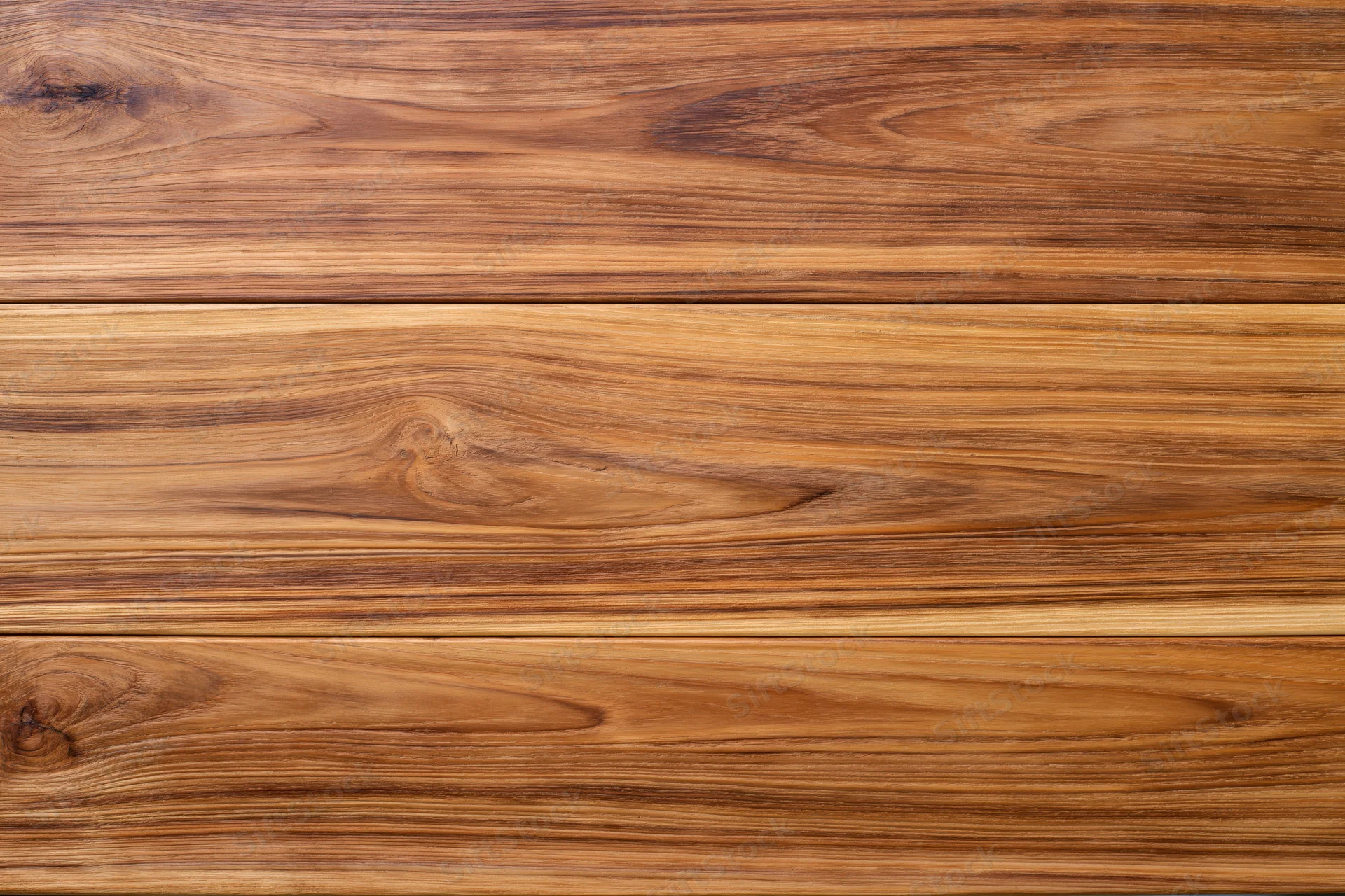 Close-up of smooth teak wood surface with horizontal grain pattern