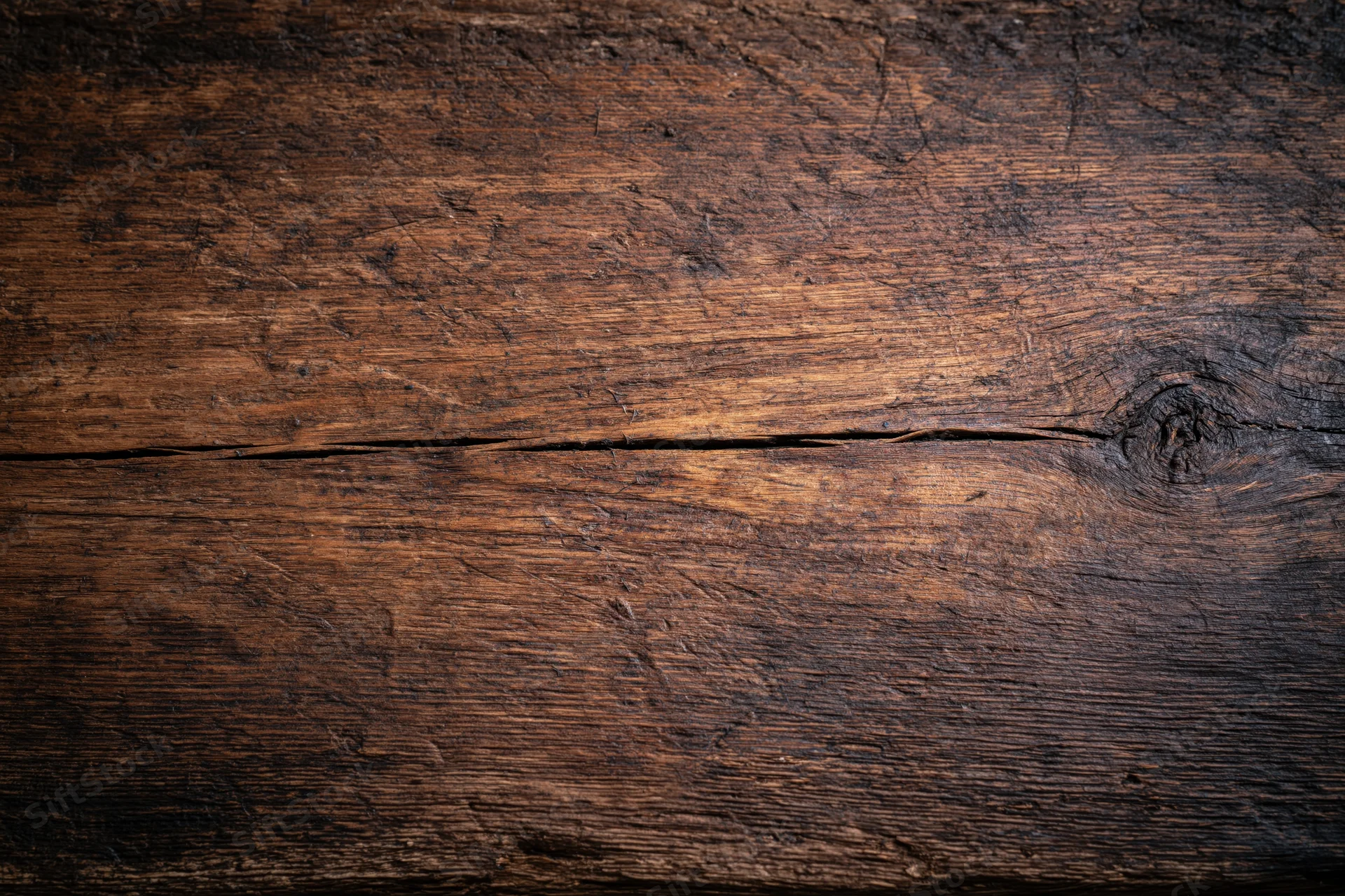 Close-up of weathered wooden surface with visible grain and knots, flat lay view