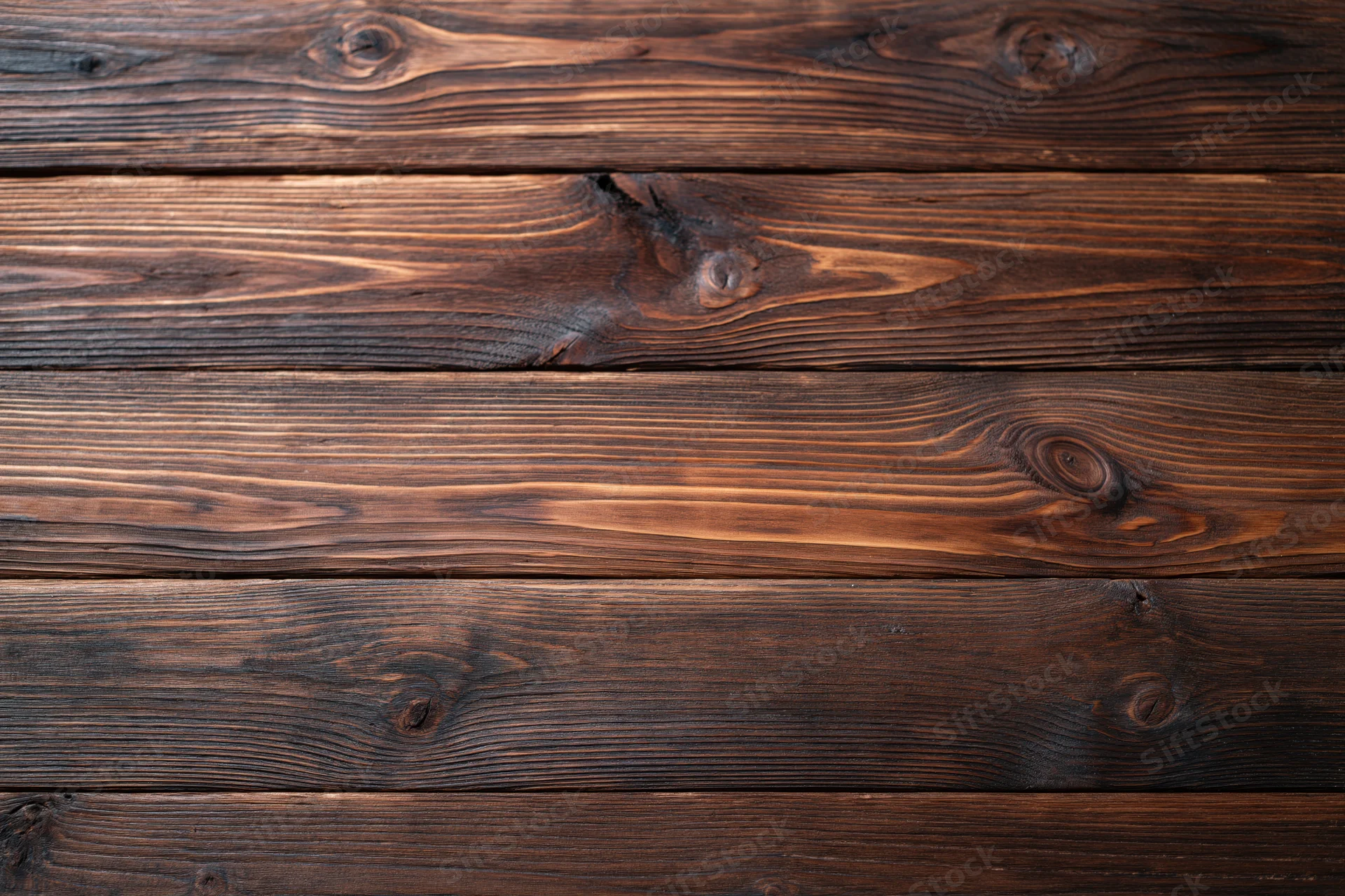 Close-up of aged dark walnut wooden planks arranged horizontally as a textured surface