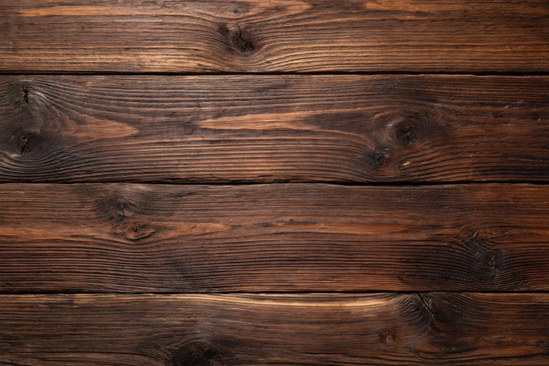 Close-up of dark aged walnut wooden planks arranged horizontally as a textured surface