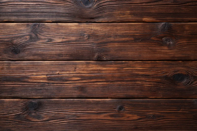 Close-up of dark aged walnut wooden planks arranged horizontally as a textured surface