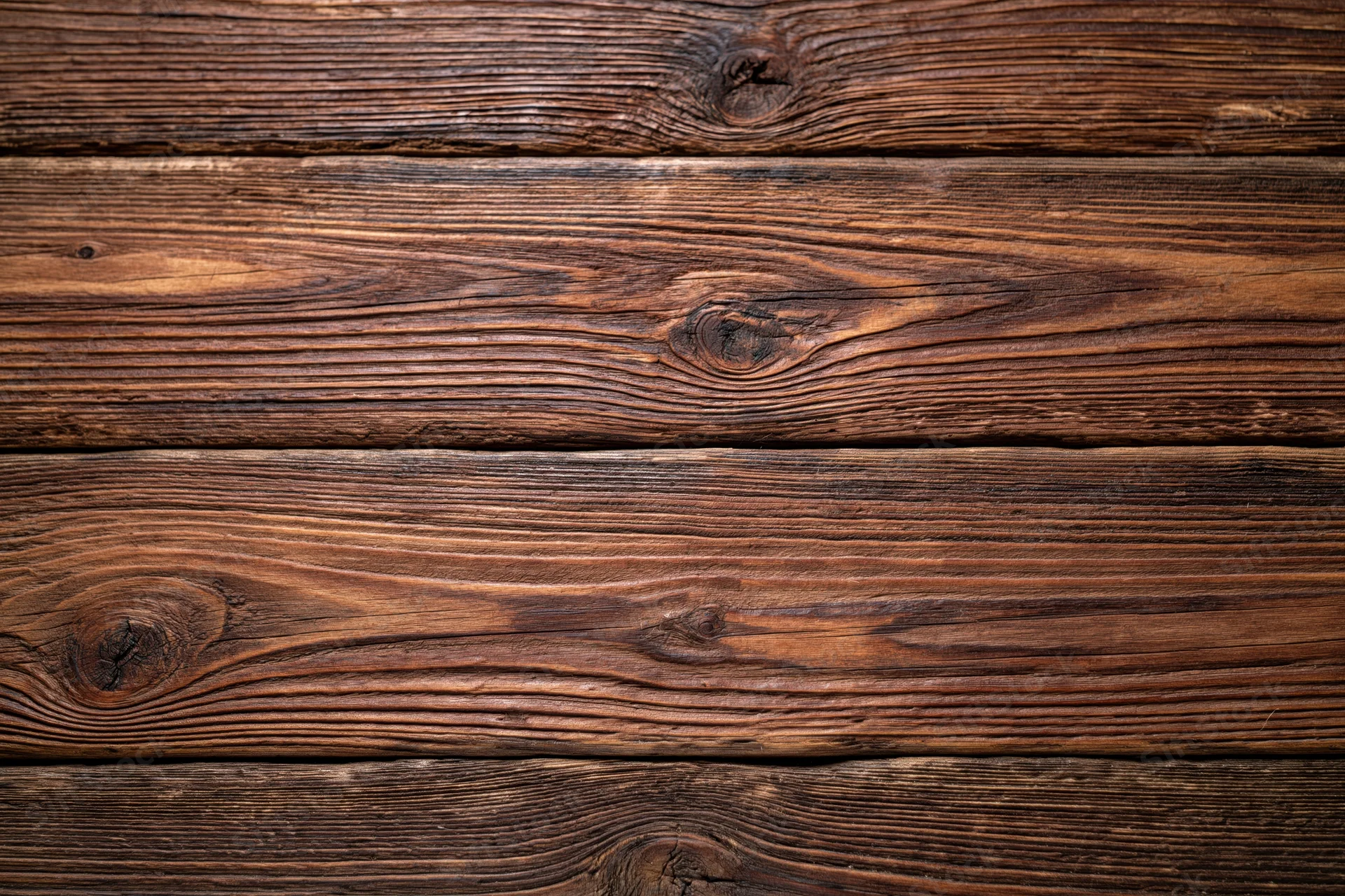 Close-up of aged dark walnut wooden planks arranged horizontally as a textured surface