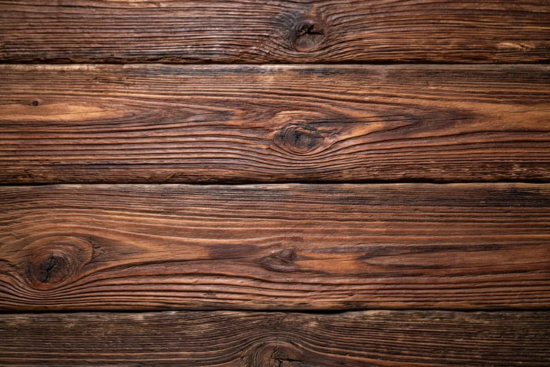 Close-up of aged dark walnut wooden planks arranged horizontally as a textured surface