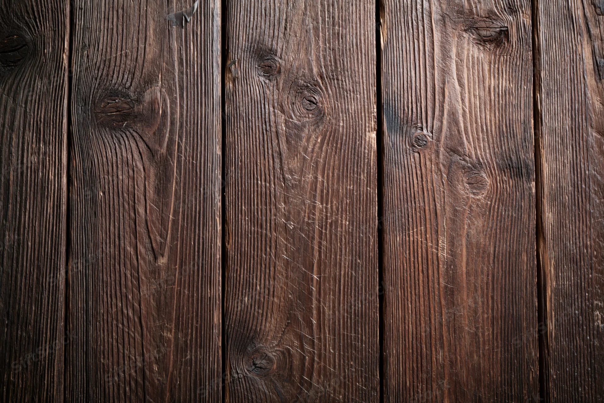 Close-up of aged dark wooden planks arranged vertically filling the frame